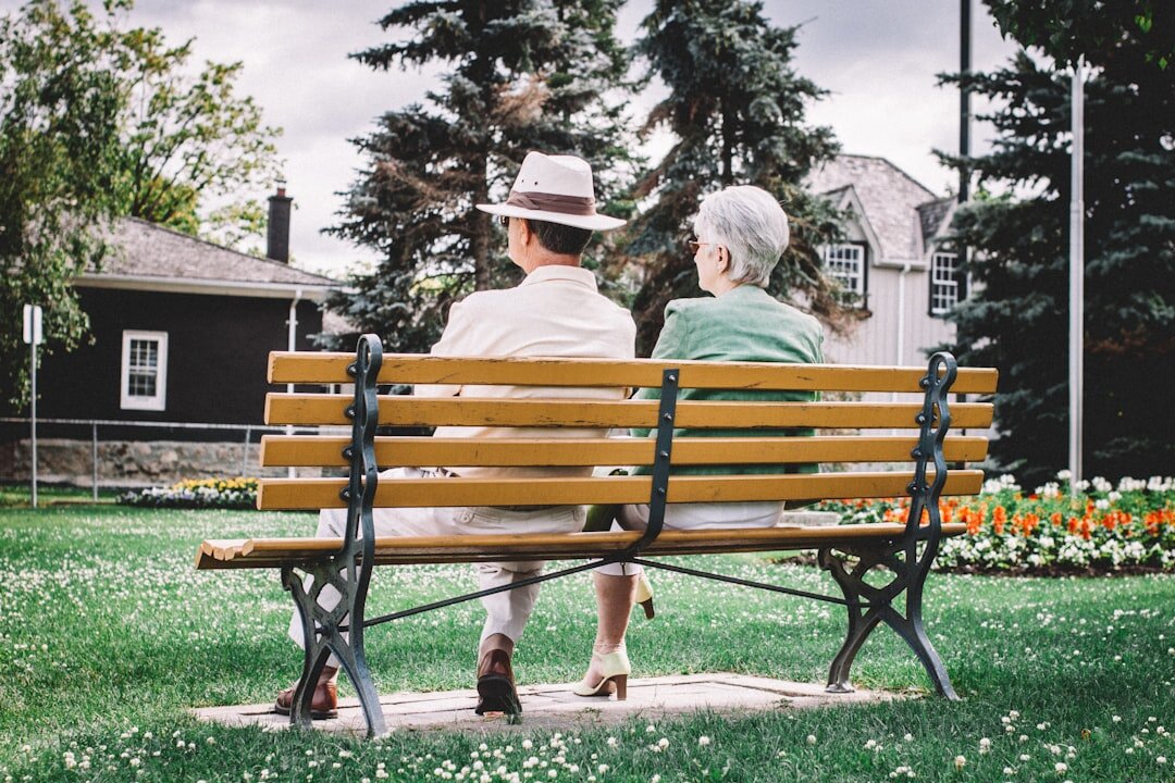 elderly neighbors chatting on bench