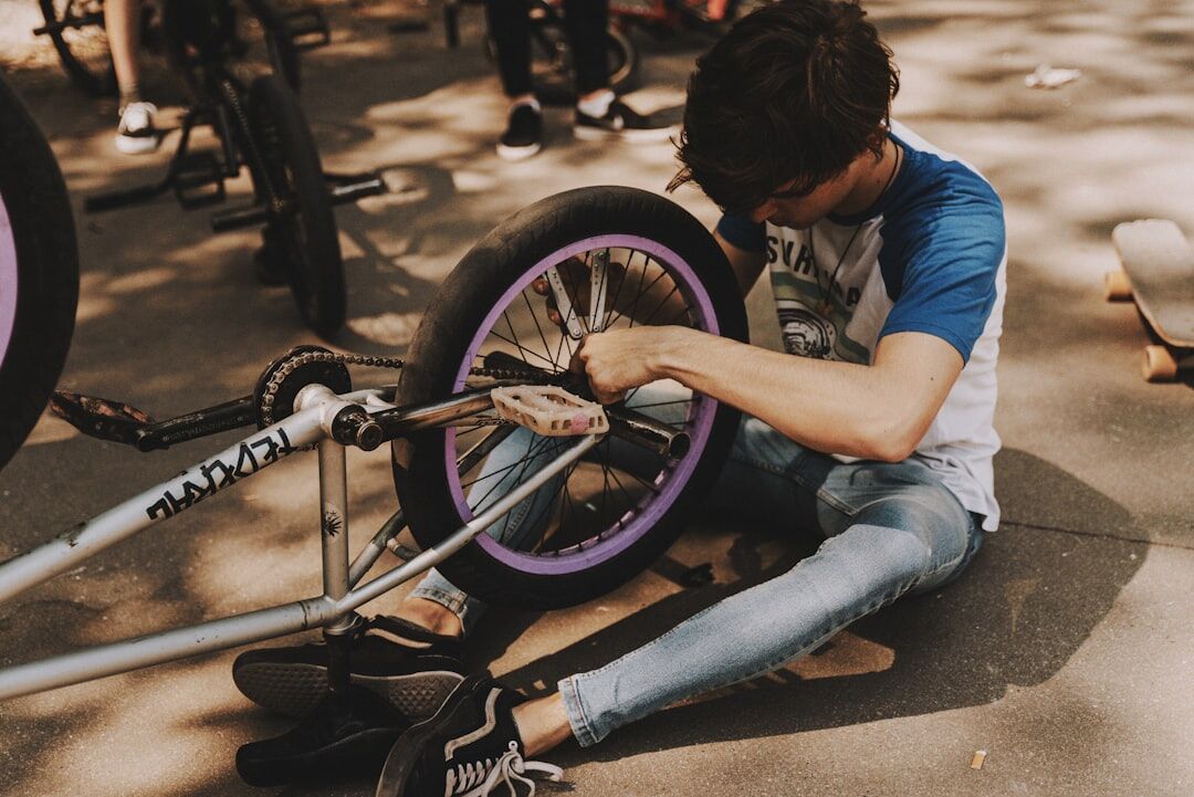 young man fixing bicycle